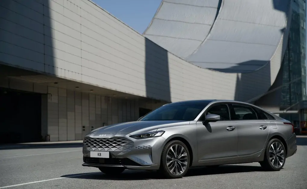 silver car parked in front of futuristic building