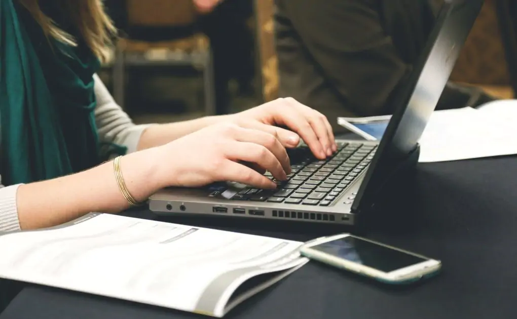 woman typing on laptop