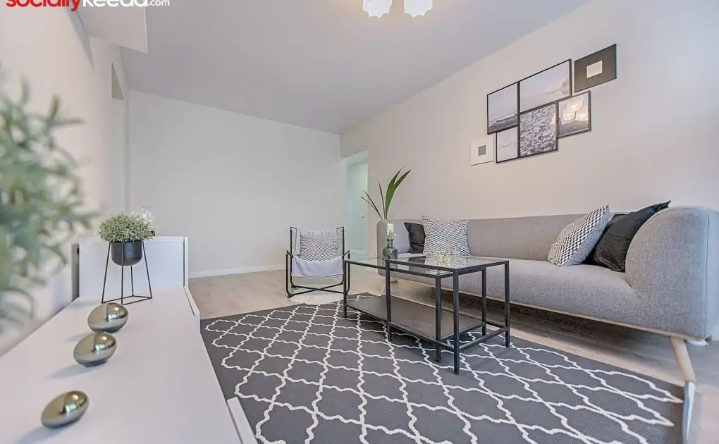 three gray ornaments on white wooden desk inside living room