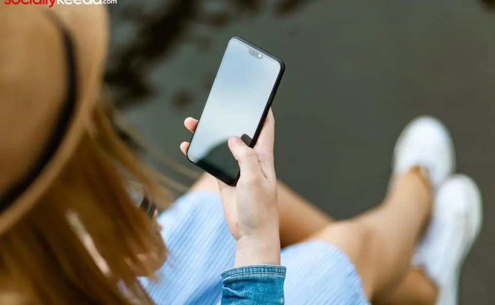 person holding smartphone white sitting