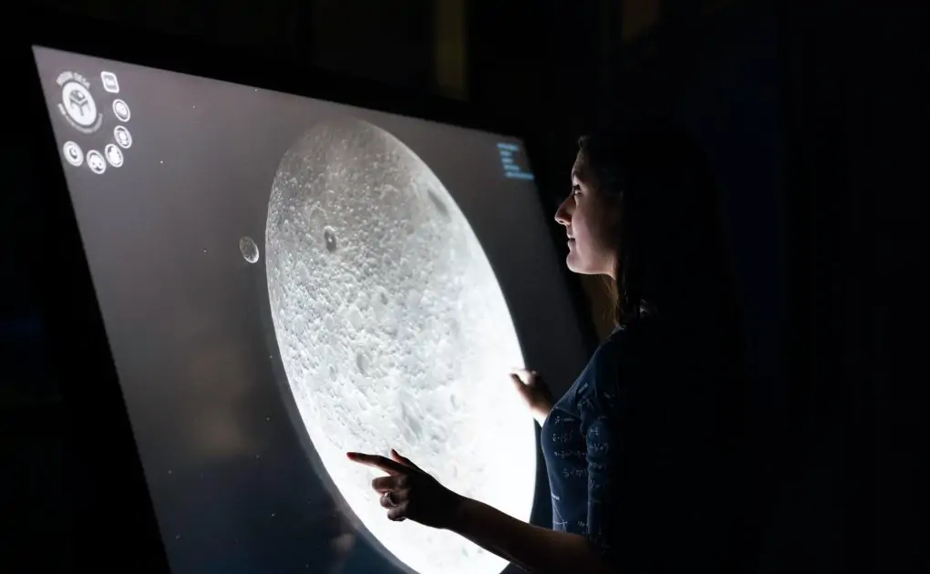 woman studying moon surface