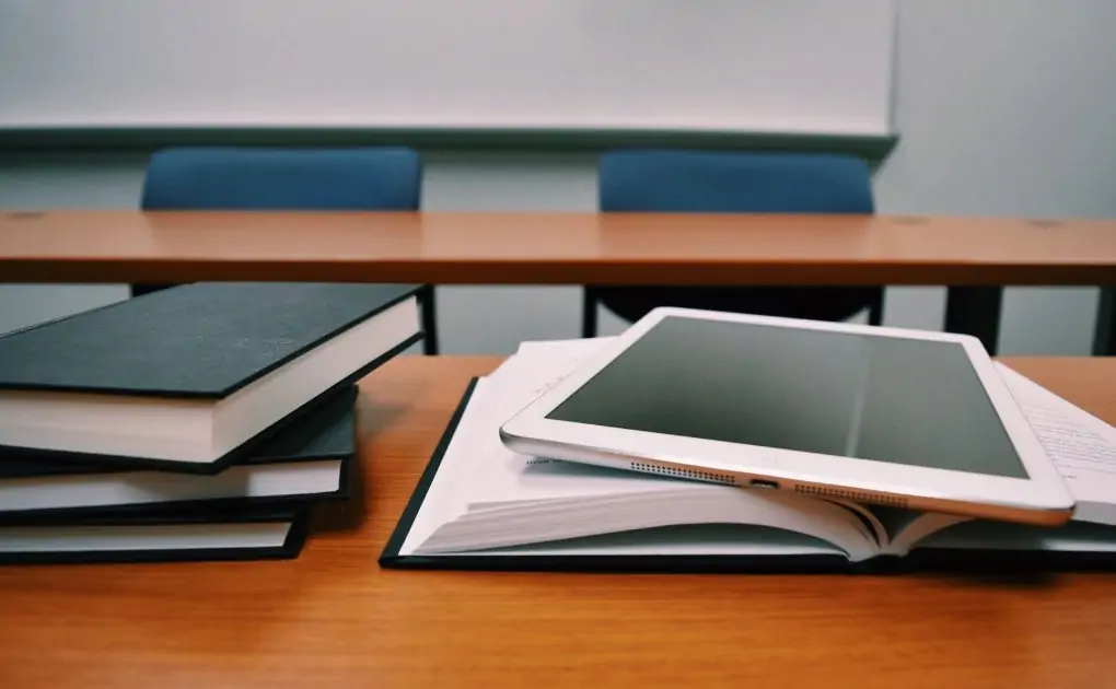 silver ipad on white book page