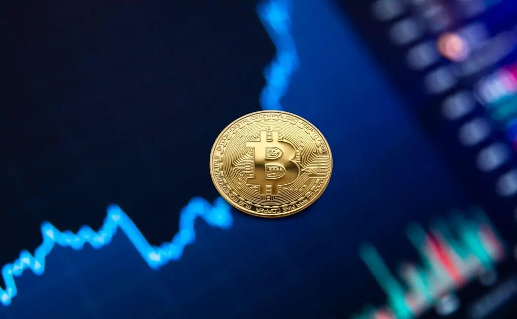 gold bitcoin coin on background of growth chart