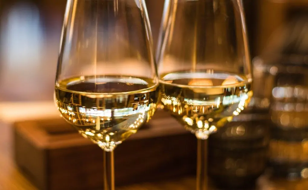close up photography of wine glasses,black labeled wine bottle