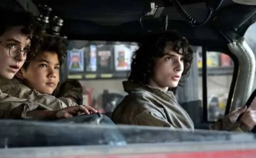 Afterlife Image Takes Ecto-1 for A Spin with Finn Wolfhard