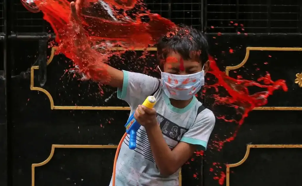 Photos: Covid-19 dampens Holi celebrations in India