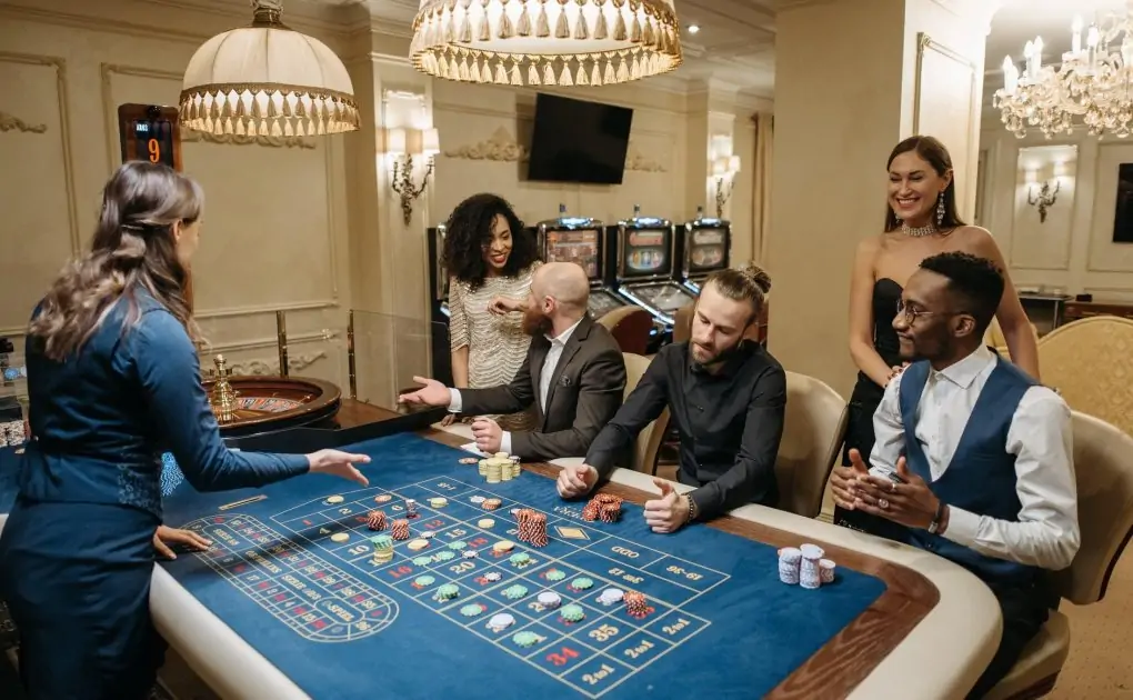 group of gamblers playing on roulette table