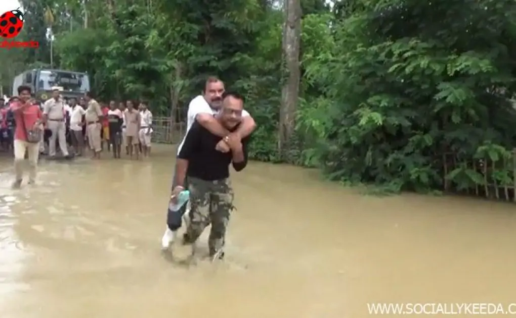 Assam Floods: Sibu Misra, BJP MLA From Lumding Assembly, Takes Piggyback Ride on the Back of a Rescue Worker; Watch Video