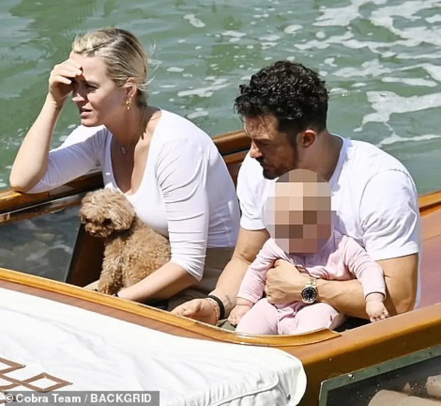 Katy Perry and Orlando Bloom enjoy a boat ride in the bright sunshine along the canals of Venice