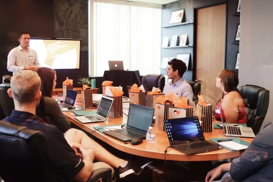 A team in an office discussing a request for a proposal during a meeting