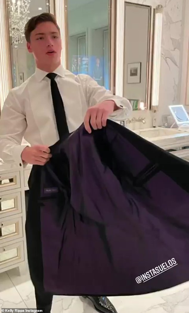 Getting ready:  Joaquin was seen pulling on his black tuxedo jacket