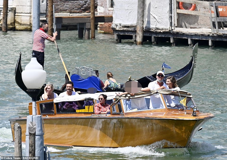 Seeing the sights: They bypassed a gondola on the canal as they chatted and laughed, before being dropped off at their hotel