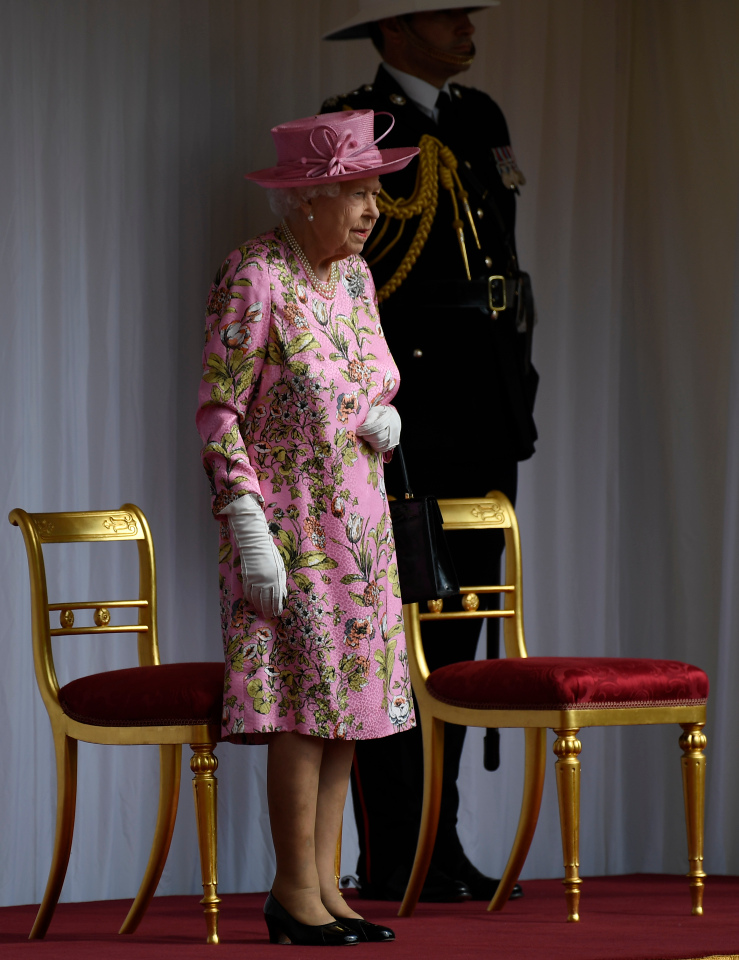 Despite the sweltering heat, the Queen stood to await the president and first lady