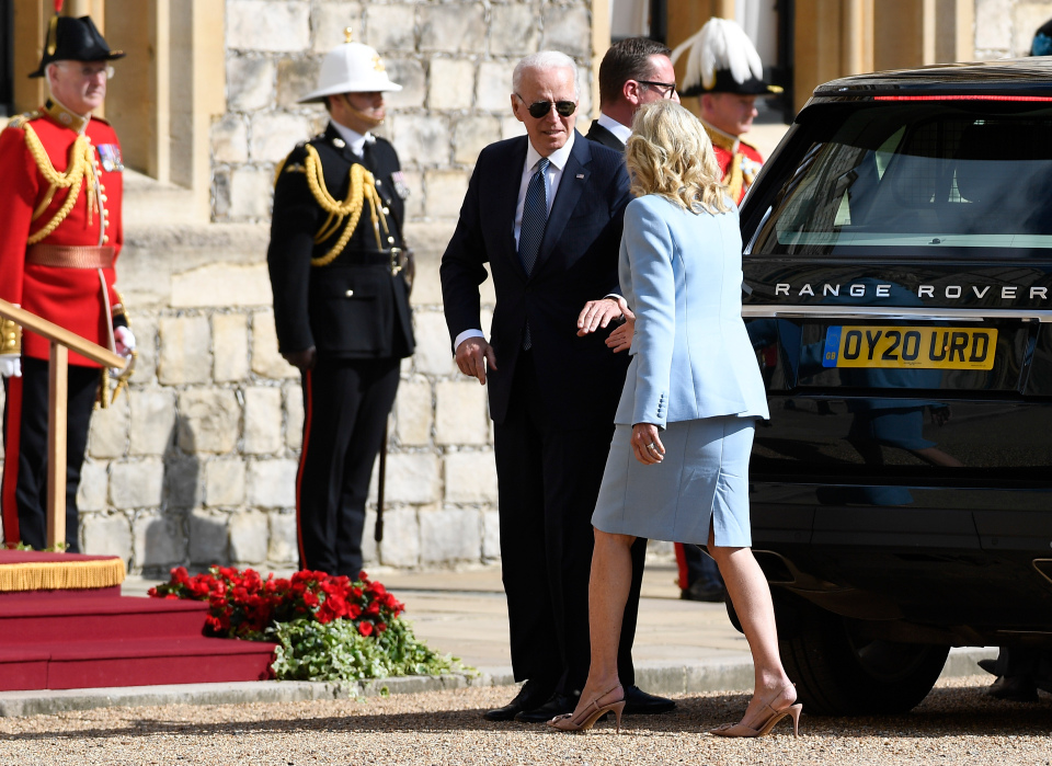 The first lady, dressed elegantly in light blue, took her husband's hand as they arrived