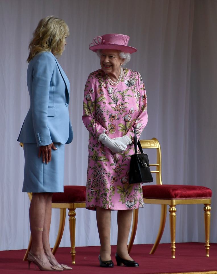 The Queen and the first lady smiled at each other as they chatted in Windsor's quadrangle
