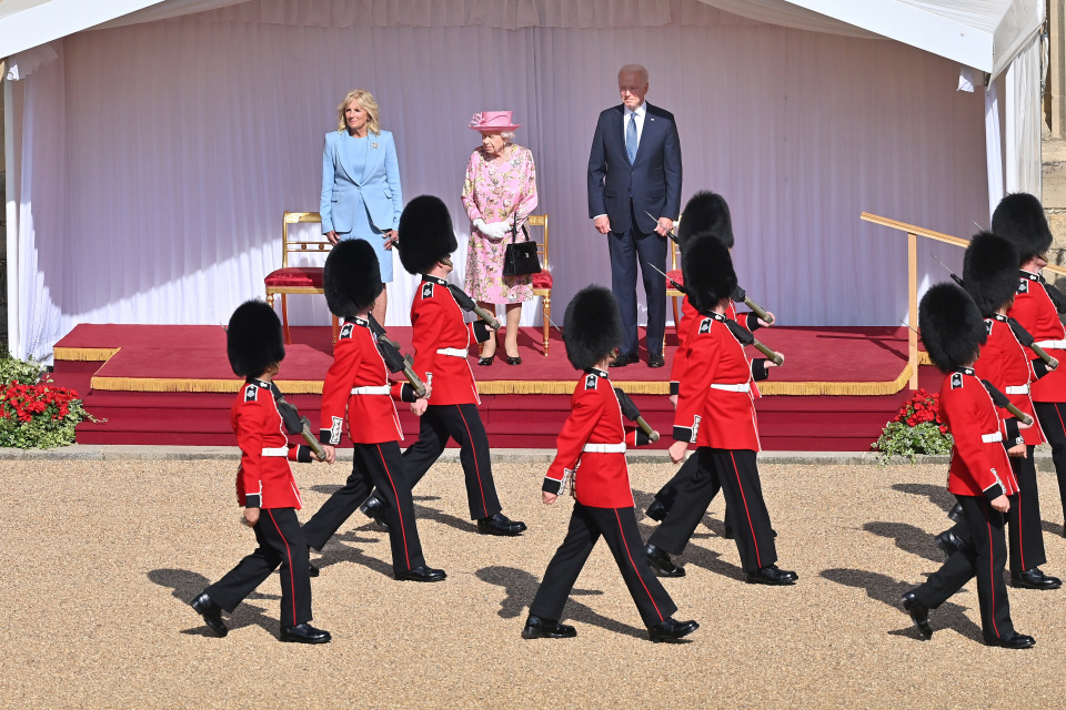 Mr Biden removed his aviator sunglasses ahead of the Guard of Honour