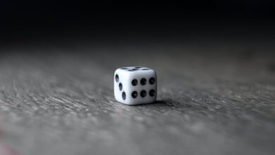 Small White Dice Placed On Wooden Table